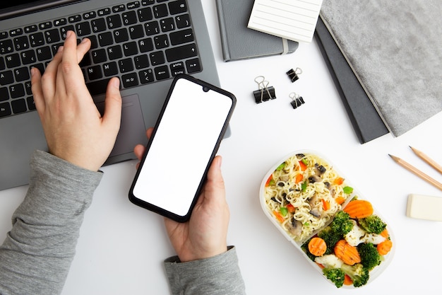 Woman working and holding her phone