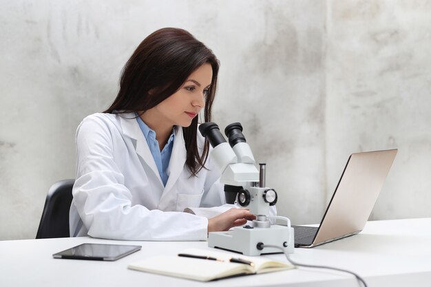 Woman working in the lab with a microscope