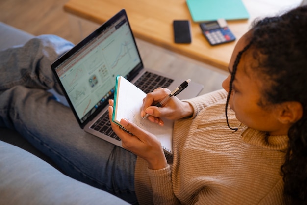 Woman working on laptop high angle