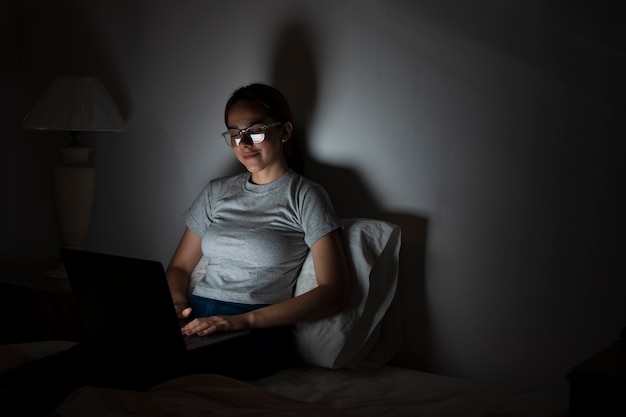 Woman working on laptop late at night