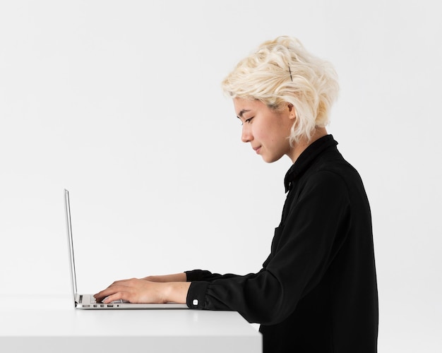 Woman working on laptop medium shot