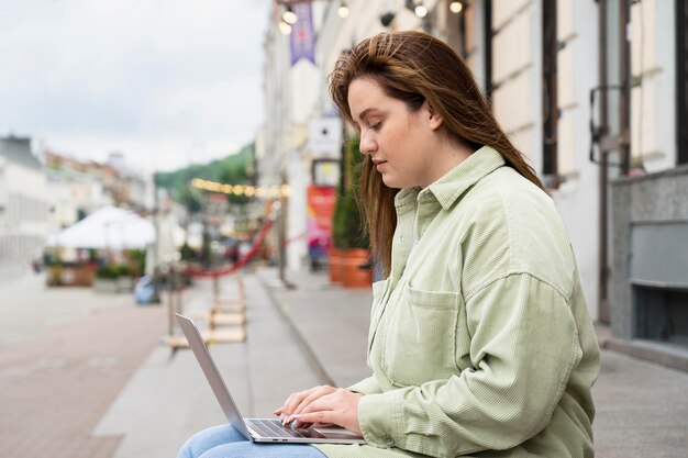 Woman working on laptop medium shot