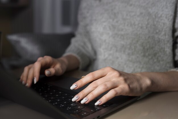 Woman working at laptop during night