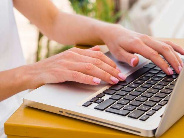 Woman working on laptop outside