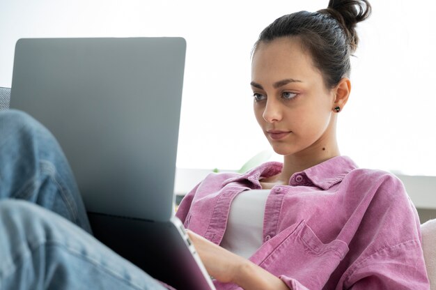 Woman working on laptop side view