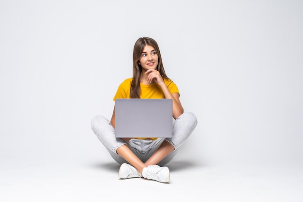 Woman working on a laptop on a white backgorund