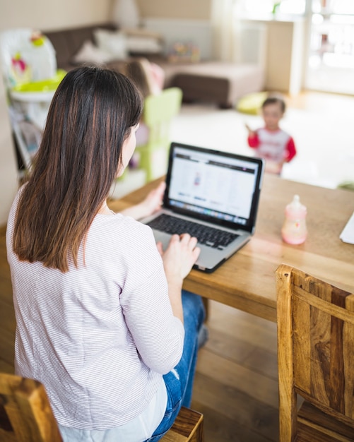 Free photo woman working on laptop over wooden desk