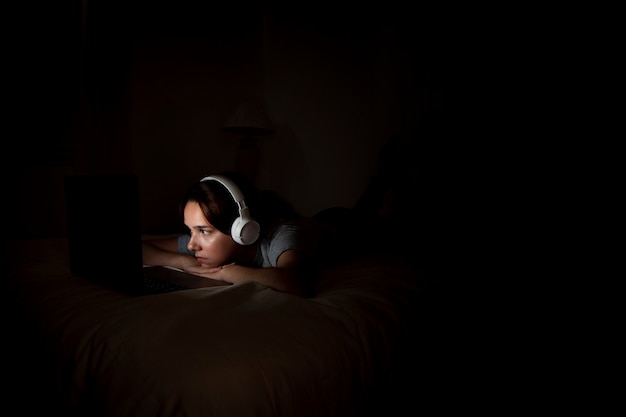 Woman working late on laptop at home