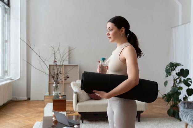 Woman working out after online fitness instructor