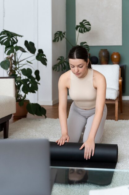 Woman working out after online fitness instructor