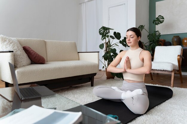 Woman working out after online fitness instructor