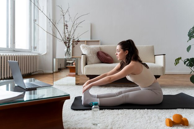 Woman working out after online fitness instructor