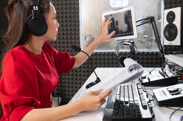 Woman working at radio with professional equipment