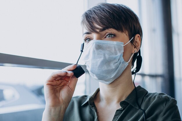 Woman working at record studio and wearing mask