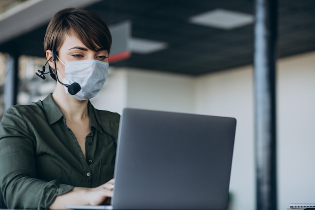 Free photo woman working at record studio and wearing mask