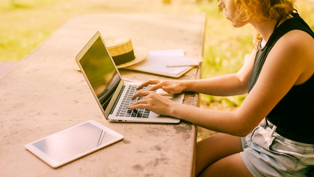 Woman working at table outdoors