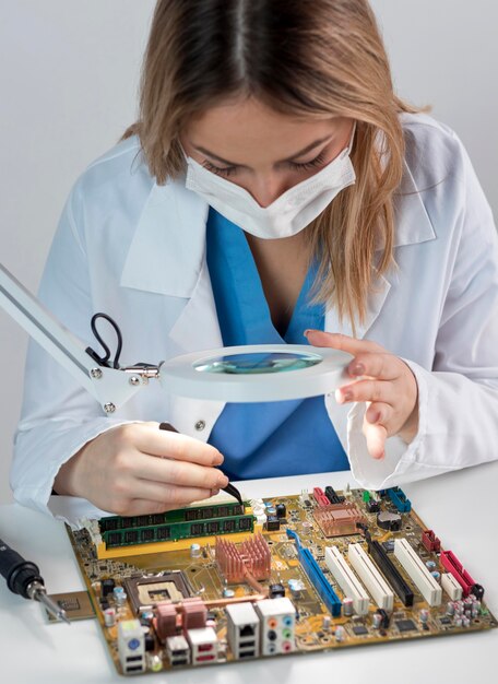 Woman working in technology with mask