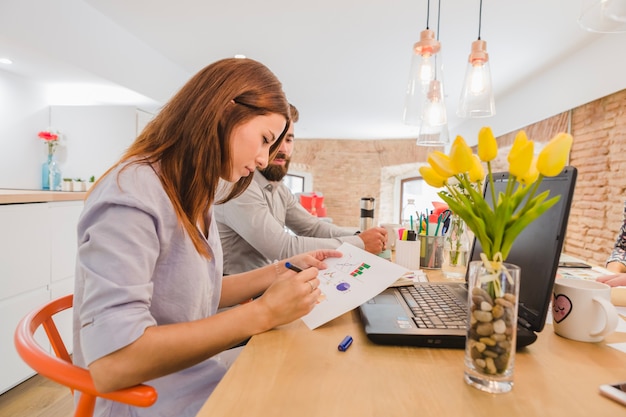 Woman working with colleagues on diagrams