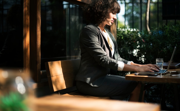 Free Photo woman working with laptop at coffee shop