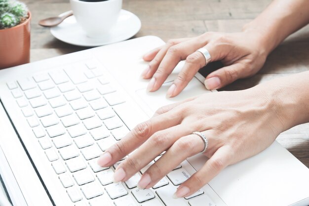 Woman working with laptop computer at home