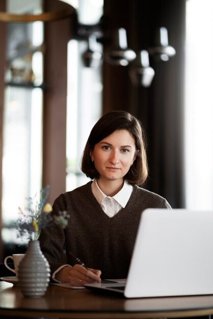 Woman working with laptop front view