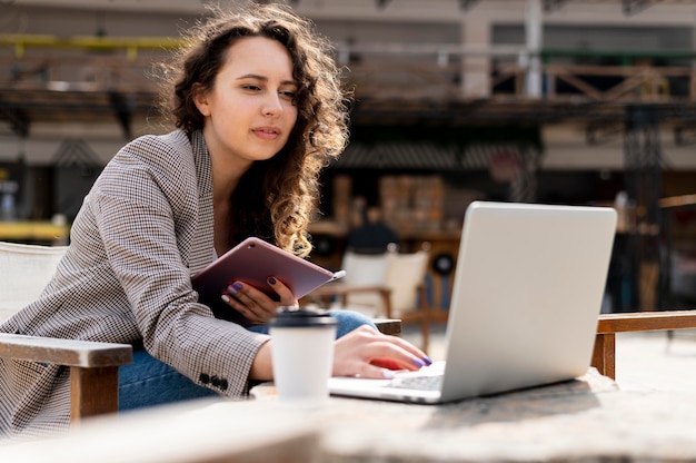 Woman working with laptop medium shot