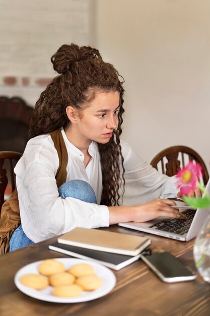 Woman working with laptop medium shot