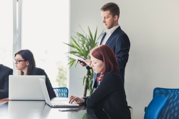 Woman working with laptop on meeting