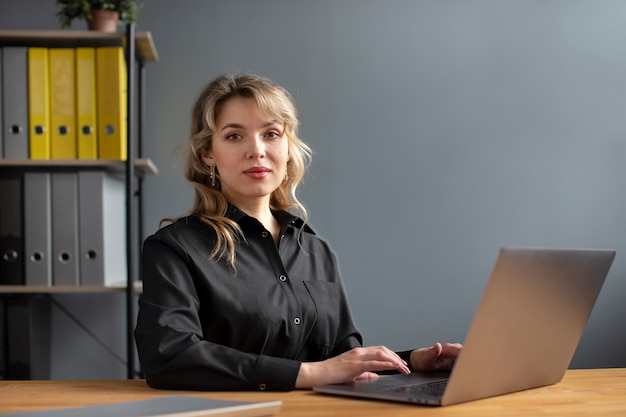 Woman working with laptop side view