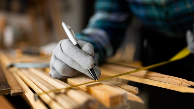 Woman working in workshop measuring