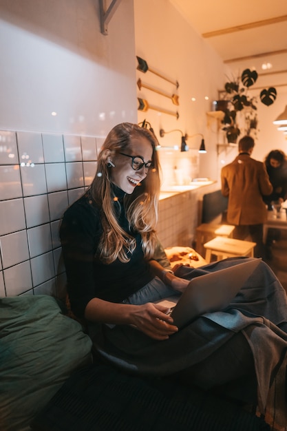 Woman works at a cafe in the evening