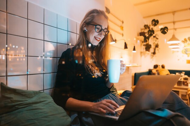 Woman works at a cafe in the evening