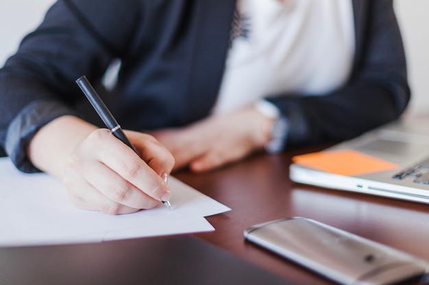 Free photo woman writing in office