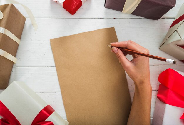 Woman writing on paper with pencil