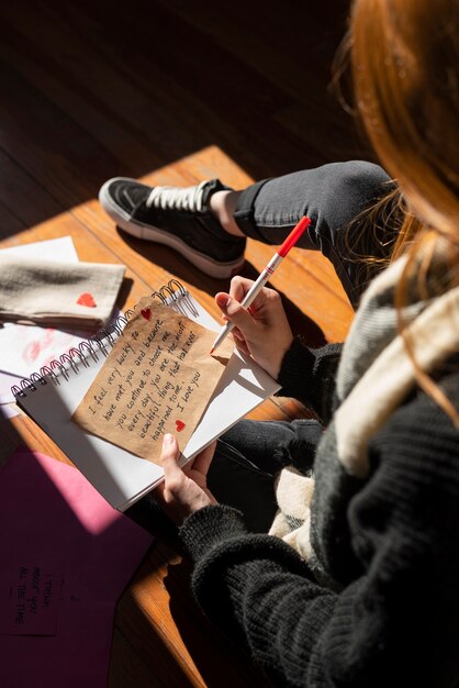 Woman writing a romantic love letter to someone