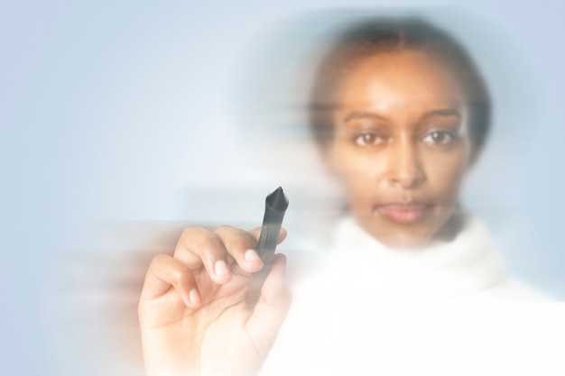 Woman writing on virtual screen with double exposure effect