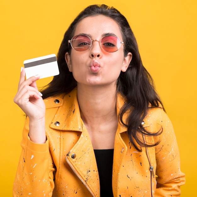 Free photo woman in yellow jacket blowing a kiss