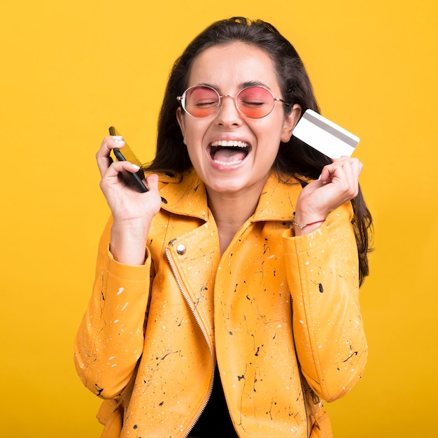 Free photo woman in yellow jacket happy about sales