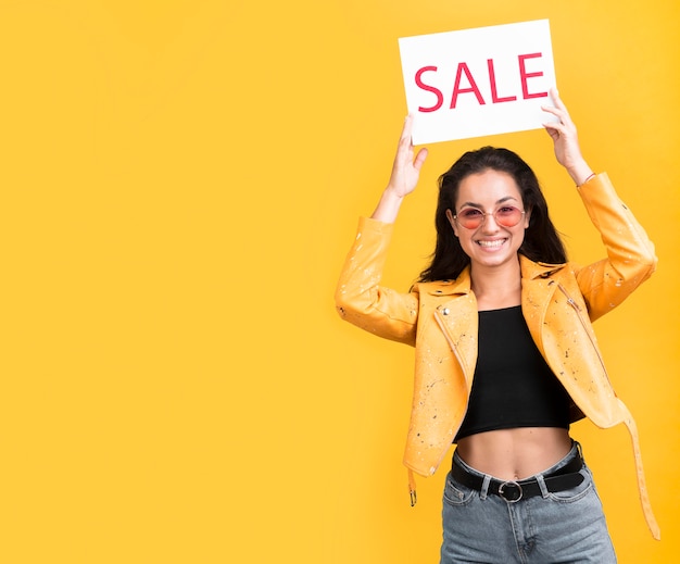 Woman in yellow jacket sale banner copy space