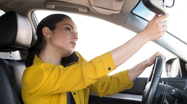 Woman in yellow shirt doing multiple tasks