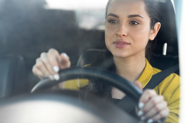 Free photo woman in yellow shirt drives