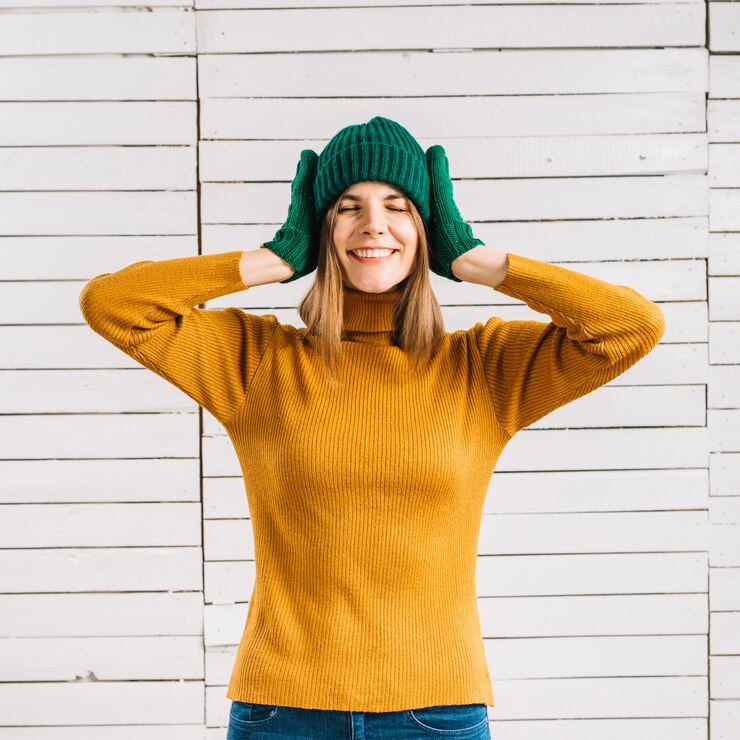 Free Photo woman in yellow sweater covering ears