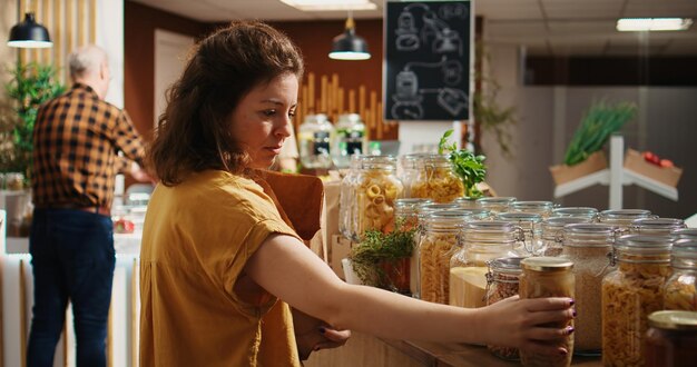 Woman in zero waste shop using paper bag