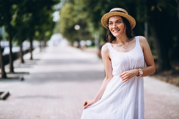 Womanwearing dress and hat outside in park