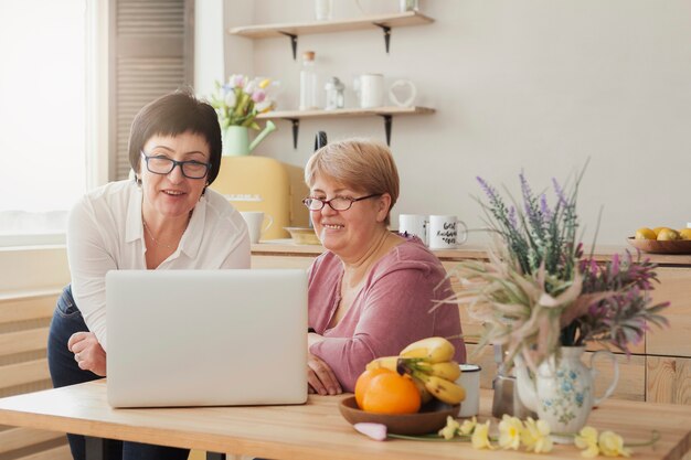 Women adults looking at a laptop