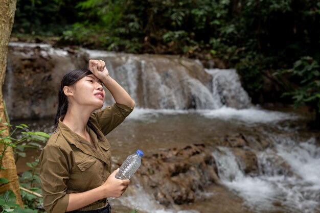 Women are hiking drinking fresh water in the forest