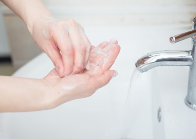 Women are washing their hands with disinfectant foam to keep the virus healthy.