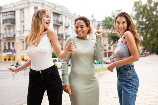women being happy and dancing outdoors