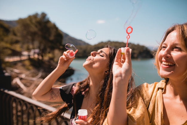 Women blowing and catching bubbles