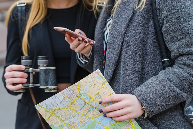 Women browsing smartphone with map